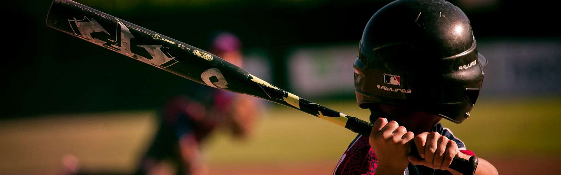 A young boy practicing baseball at a sports clinic.