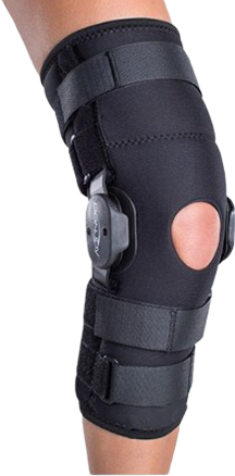 A person’s knee wearing a black orthopedic knee brace with straps, side hinges, and an open patella design, providing effective orthoses support.